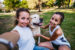 two young women with dog in park